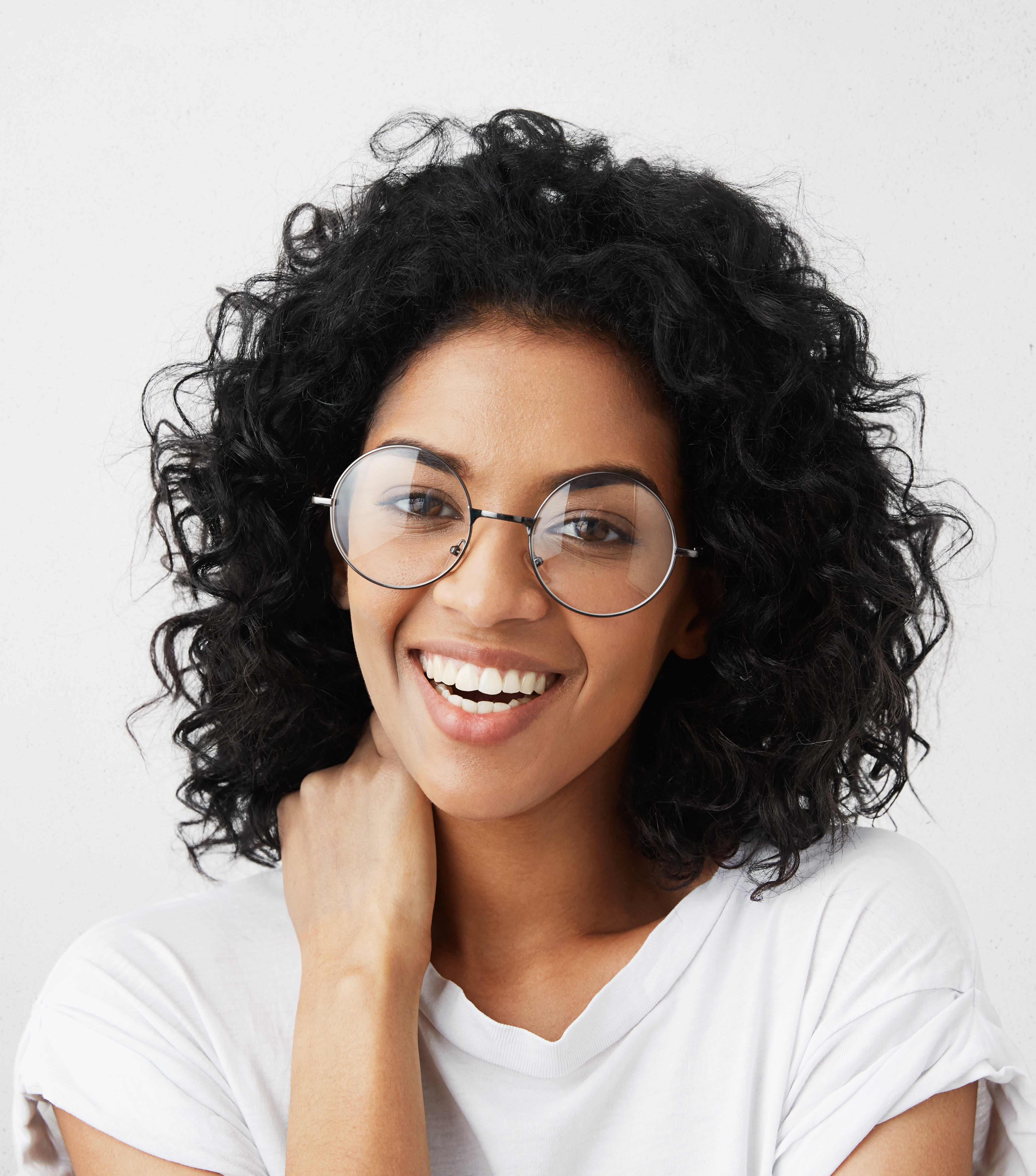 positive human emotions portrait beautiful charming female student with afro hairstyle having shy look laughing wearing stylish round eyeglasses touching her neck with hand 1